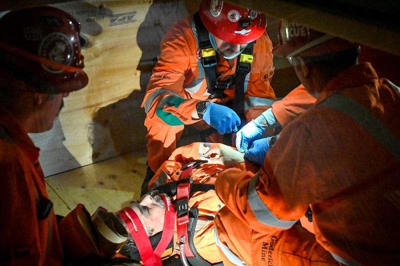 Mine rescue volunteers help victim on stretcher
