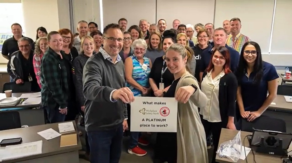 Group of WSN staff holding sign