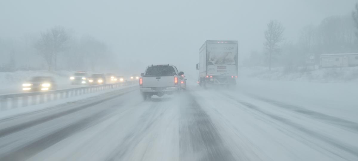 Trucks and cars on snowy highway