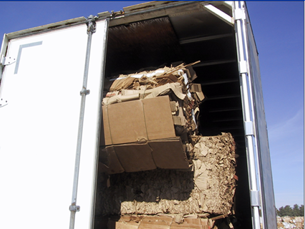 Cardboard bale leaning up against truck door