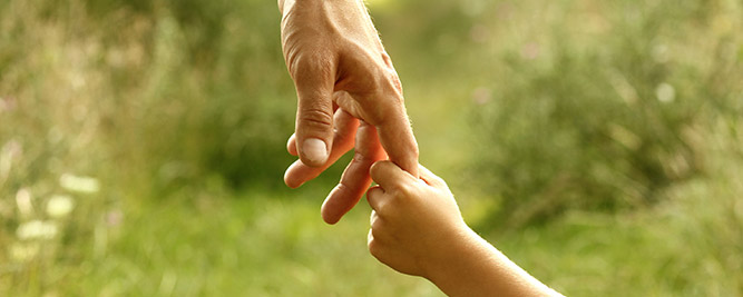 Worker holding child's hand