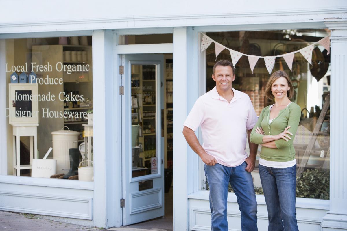 Man and woman standing in front of store